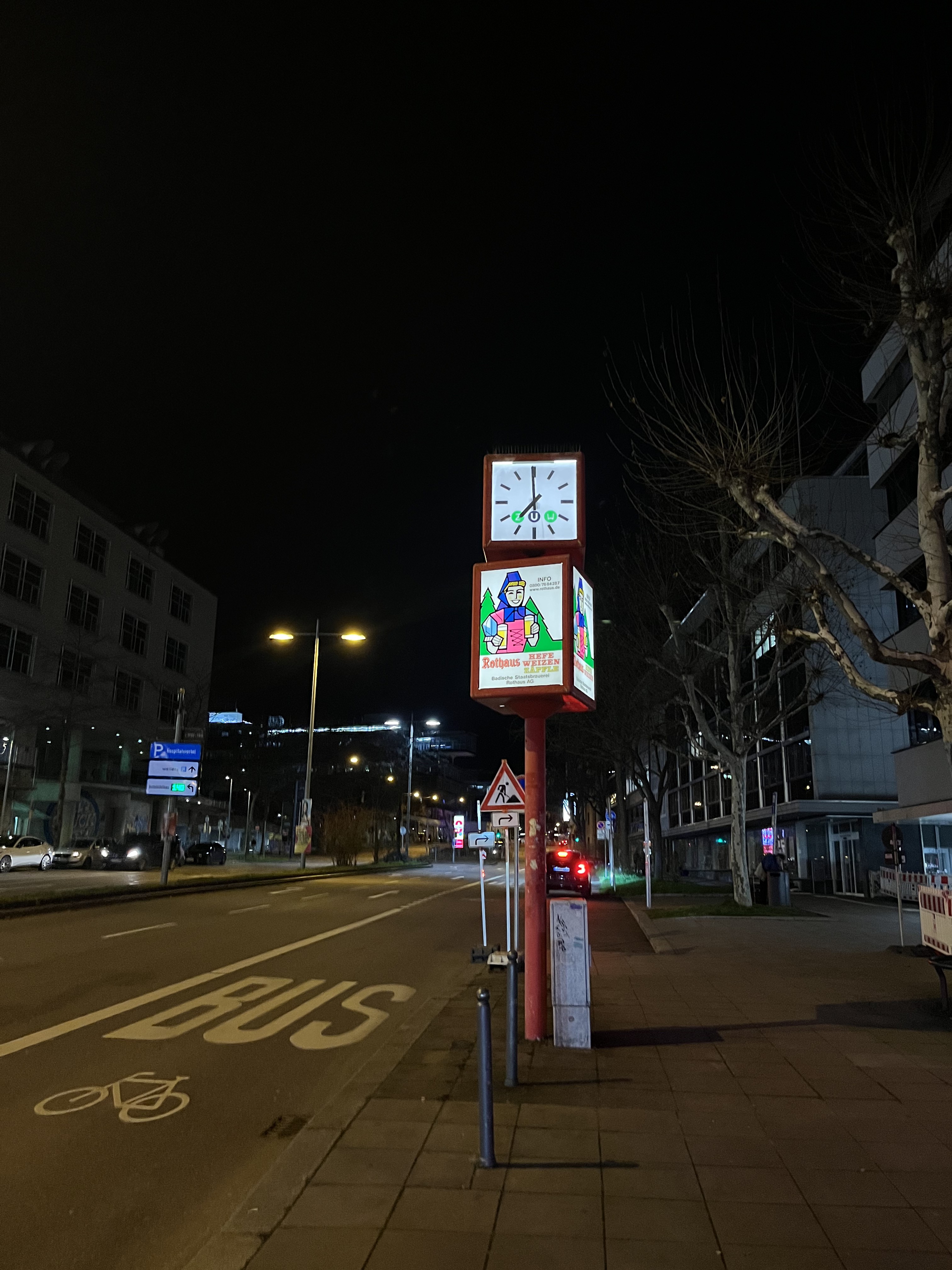 clock and rotating advert at 